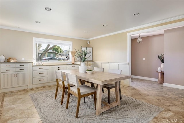 dining area featuring crown molding