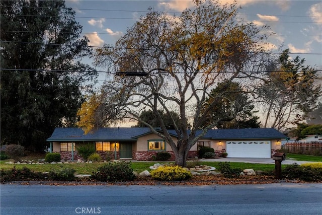 ranch-style home featuring a garage