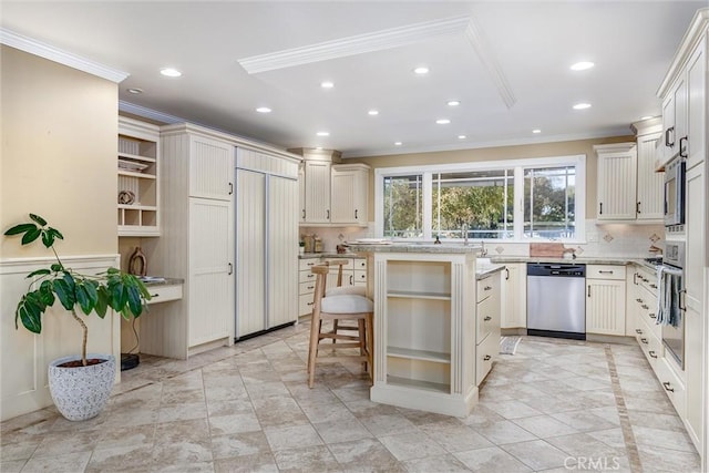 kitchen with built in appliances, a center island, a kitchen bar, and crown molding