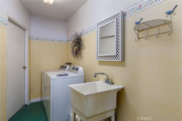 washroom featuring washing machine and clothes dryer and sink