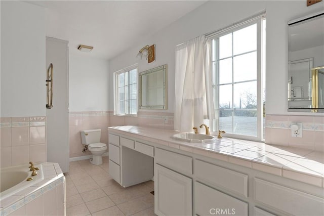 bathroom with tile patterned floors, toilet, a water view, vanity, and a bathtub