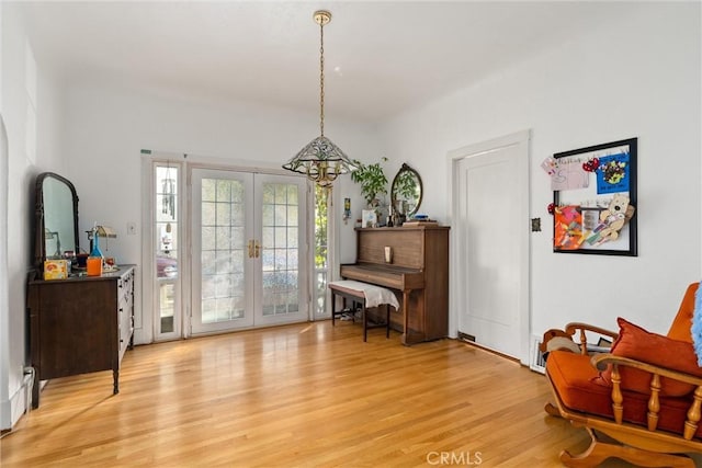 sitting room with light hardwood / wood-style flooring and french doors