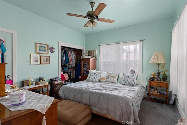 bedroom featuring dark carpet, a closet, and ceiling fan