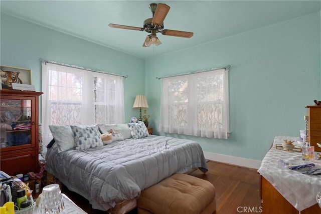 bedroom featuring ceiling fan and dark hardwood / wood-style floors