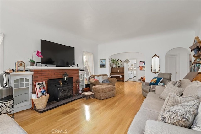 living room with wood-type flooring and a wood stove