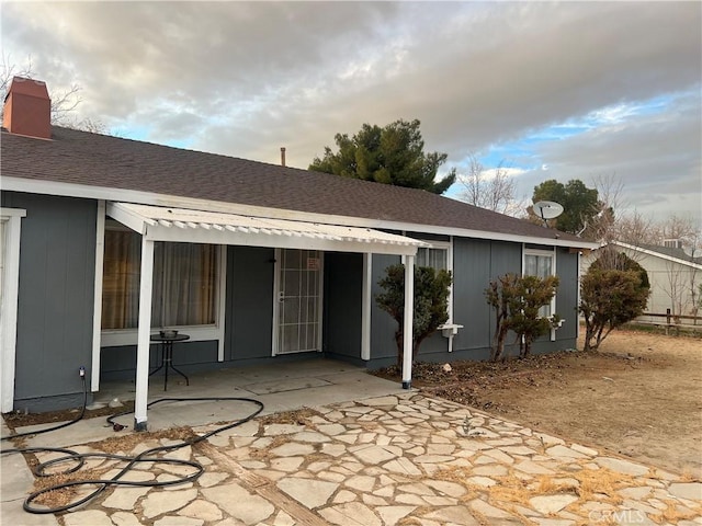 back of house with a patio