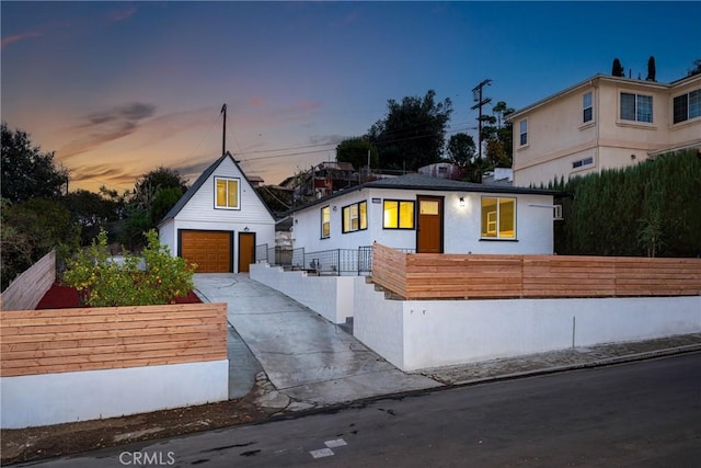 view of front of home featuring a garage and an outdoor structure