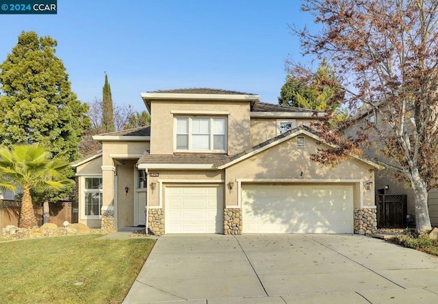 view of front of property with a garage and a front yard