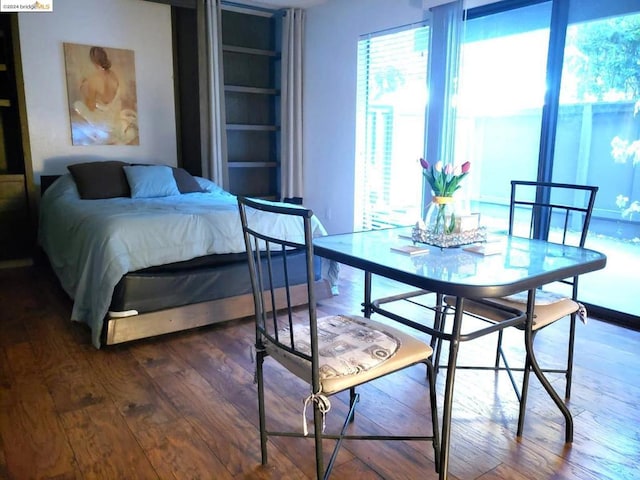 bedroom with dark wood-type flooring