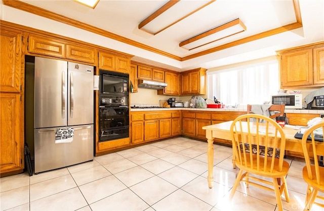 kitchen featuring black appliances, a raised ceiling, light tile patterned floors, and ornamental molding