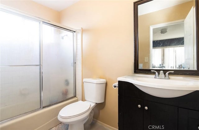 full bathroom with shower / bath combination with glass door, vanity, and toilet