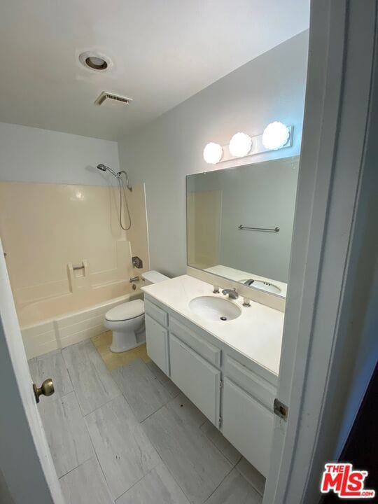 full bathroom featuring shower / bathing tub combination, vanity, and toilet