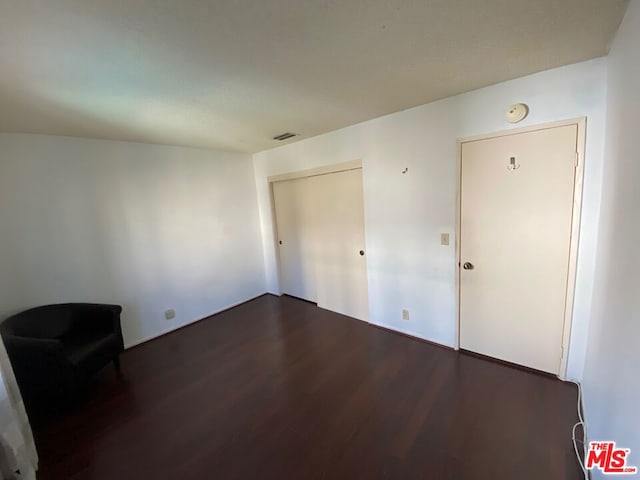 empty room featuring dark hardwood / wood-style flooring