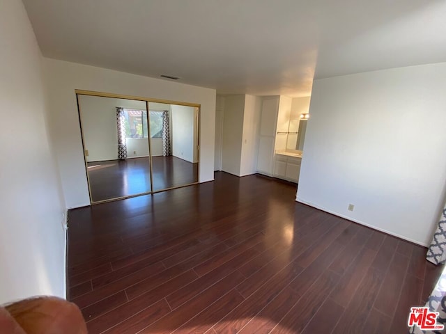 unfurnished room featuring dark wood-type flooring