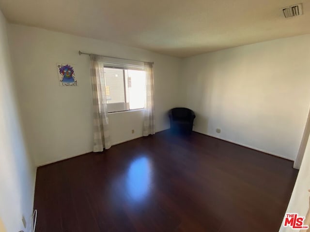 empty room featuring dark wood-type flooring