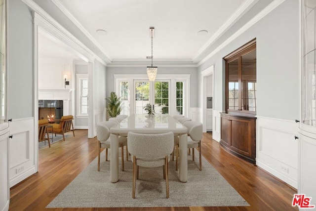 dining space featuring dark hardwood / wood-style floors and crown molding