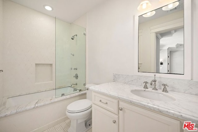 full bathroom with vanity, enclosed tub / shower combo, and toilet