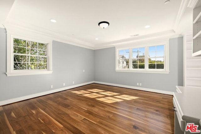 spare room with plenty of natural light, dark hardwood / wood-style floors, and crown molding