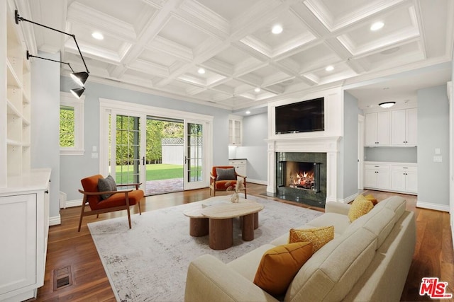 living room featuring a premium fireplace, dark hardwood / wood-style flooring, beamed ceiling, and coffered ceiling