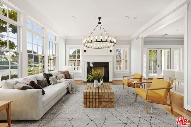 sunroom / solarium with a chandelier, french doors, and plenty of natural light