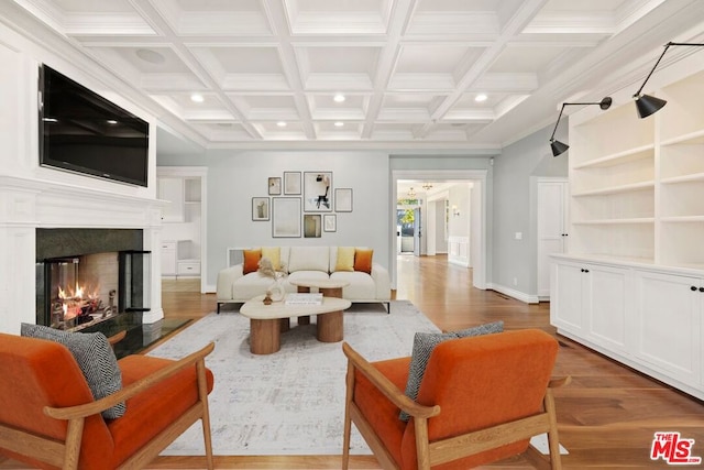 living room with a high end fireplace, dark hardwood / wood-style floors, beamed ceiling, and coffered ceiling