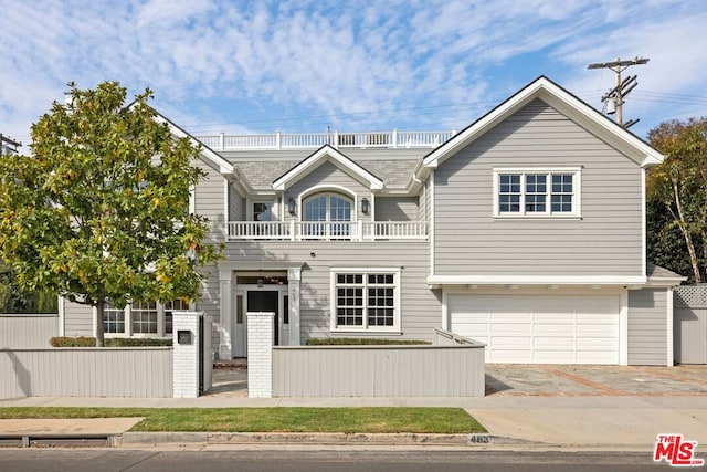 view of front facade featuring a balcony and a garage