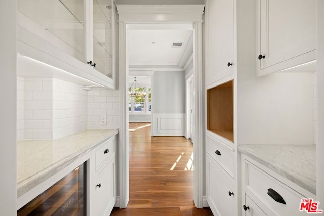 interior space with dark hardwood / wood-style flooring and beverage cooler