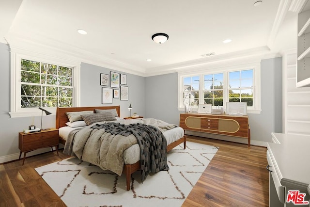 bedroom featuring ornamental molding and dark wood-type flooring