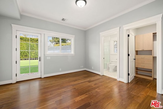 unfurnished bedroom with ensuite bath, crown molding, dark hardwood / wood-style floors, and access to exterior