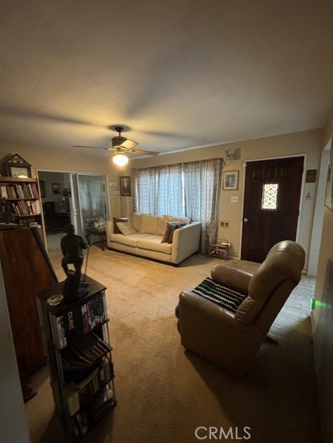 living room featuring carpet, ceiling fan, and a wealth of natural light