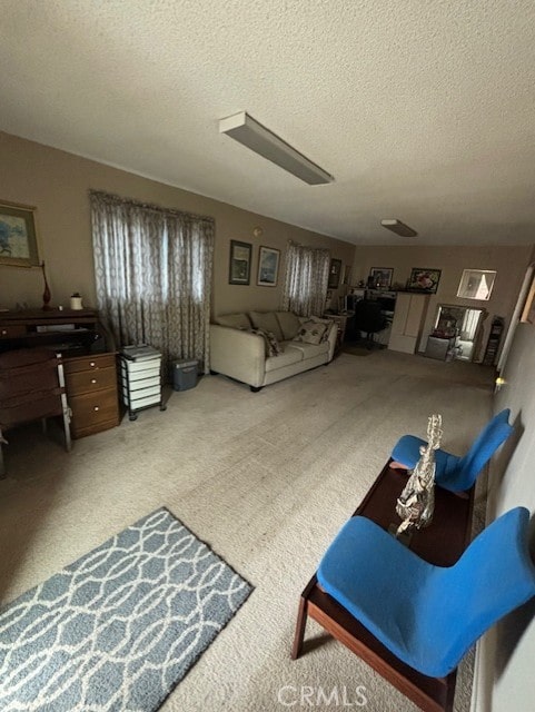 living room with ceiling fan, carpet, and a textured ceiling