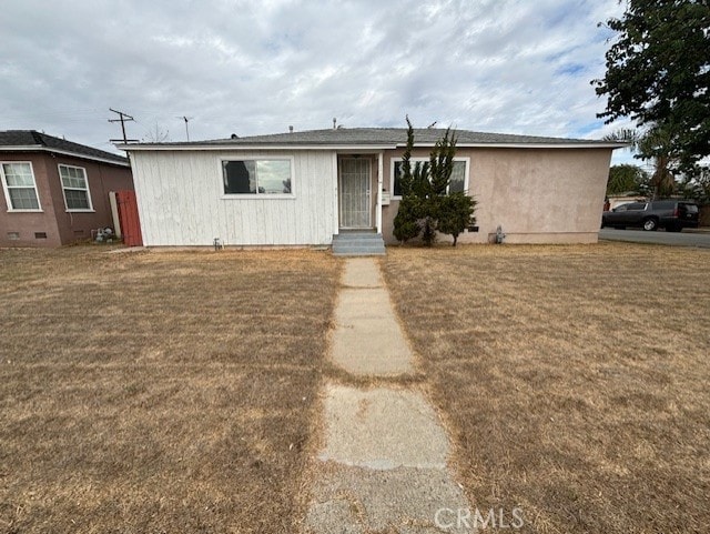 ranch-style home with a front yard