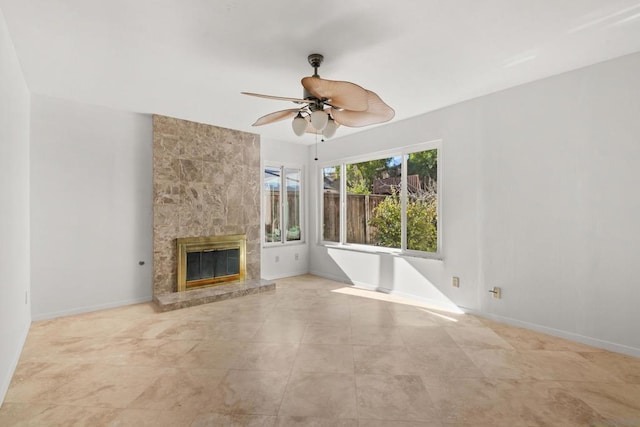 unfurnished living room featuring ceiling fan and a fireplace