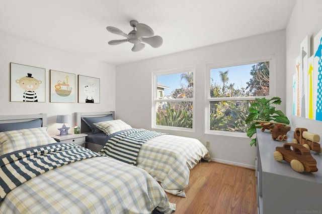 bedroom with ceiling fan and light wood-type flooring