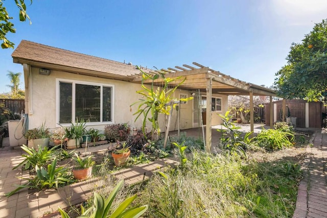 rear view of property with a pergola and a patio area