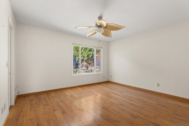 unfurnished room featuring ceiling fan and hardwood / wood-style floors