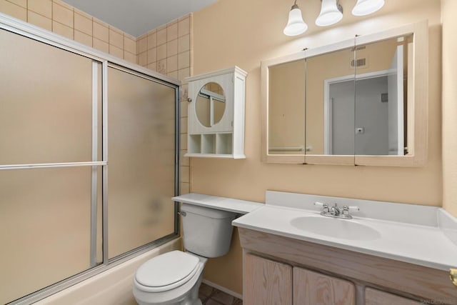 full bathroom with toilet, vanity, and shower / bath combination with glass door