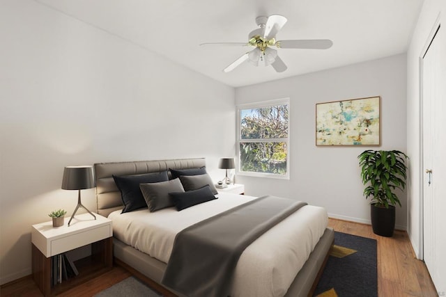 bedroom featuring ceiling fan, a closet, and hardwood / wood-style flooring