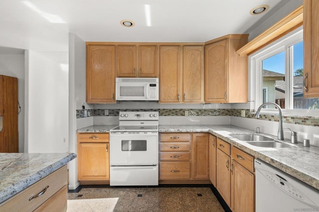 kitchen with decorative backsplash, sink, and white appliances