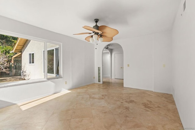 unfurnished room with ceiling fan and plenty of natural light