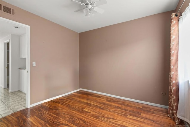 unfurnished room with ceiling fan and wood-type flooring