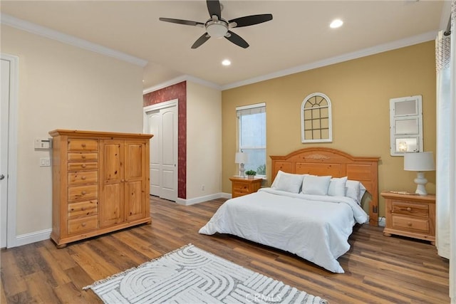 bedroom featuring ceiling fan, ornamental molding, a closet, and dark hardwood / wood-style floors