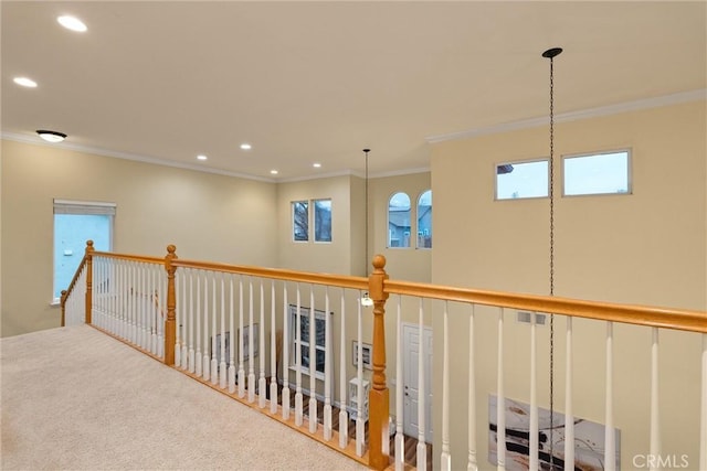 hallway with carpet and ornamental molding