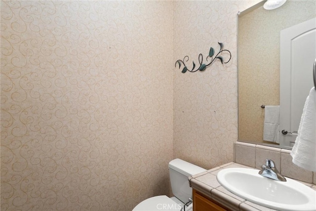 bathroom with toilet and vanity