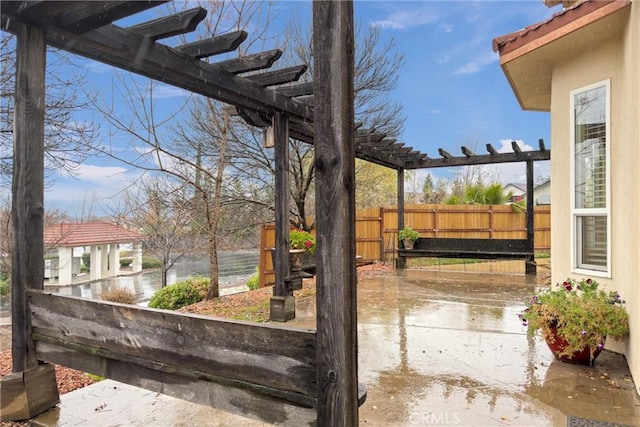 view of yard featuring a patio area, a water view, and a pergola