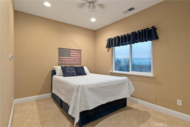 bedroom featuring ceiling fan and light carpet