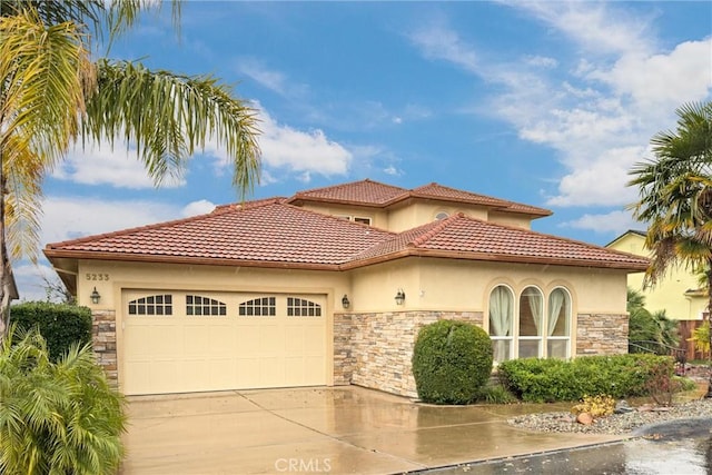 mediterranean / spanish house with a garage