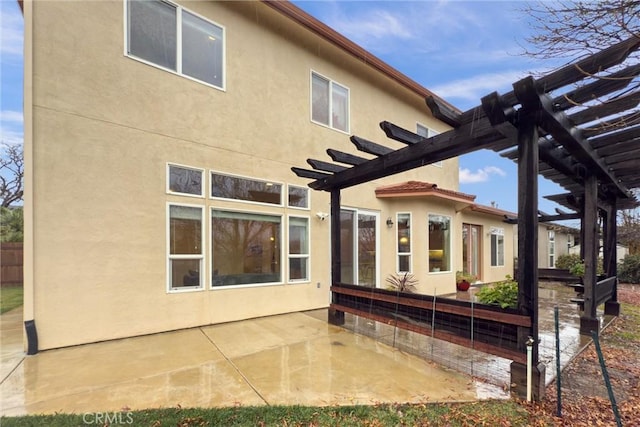 rear view of house with a patio area and a pergola