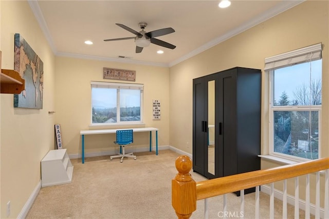 carpeted office featuring ceiling fan and crown molding