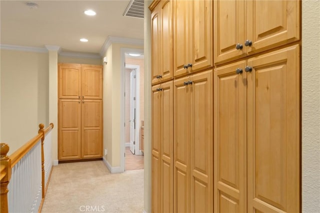 hall featuring light colored carpet and ornamental molding